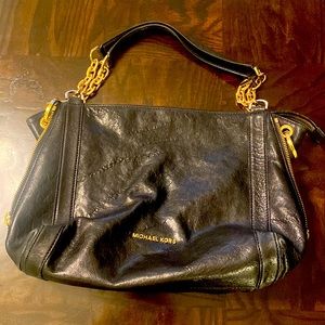 Michael Kors black purse with crossbody strap. Gold hardware. Perfect condition